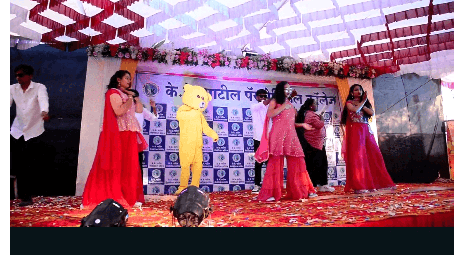 Freshers Party stage performance with teddy bear mascot and students dancing